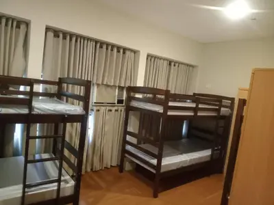 a room with three bunk beds in a room at 538 Dormitel in Manila