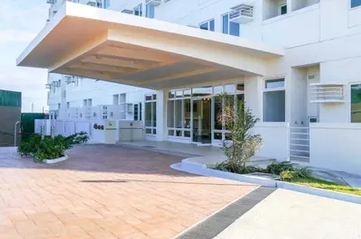 a large white building with awning in front of it at Choco Condotel- Anuva Prime 1 Couple Suite Lakeview in Manila