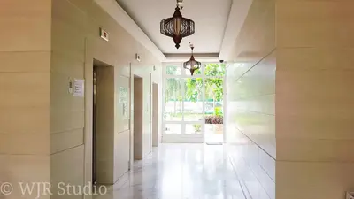 a hallway of a building with a door and a chandelier at Choco Condotel- Anuva Prime 1 Couple Suite Lakeview in Manila