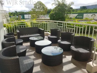 a patio with chairs and stools on a balcony at Choco Condotel- Anuva Prime 1 Couple Suite Lakeview in Manila