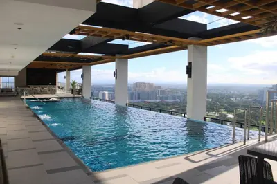 a swimming pool on the top of a building at A2J Luxury BGC Balcony Suite Near SM AURA Taguig in Manila