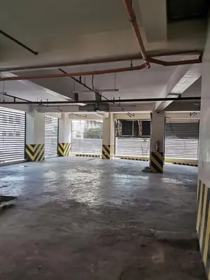 an empty parking lot with windows in an empty parking garage at G Square Residences in Manila