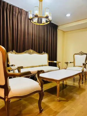 two chairs and a bench in a waiting room at Arzo Hotel Manila in Manila
