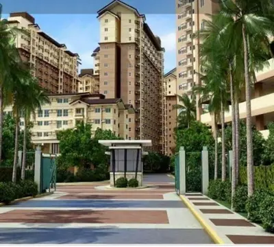 a walkway with palm trees and tall buildings at The Rochester in Manila