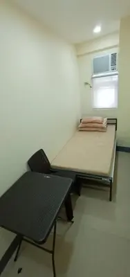 a small room with a bed and a table and a chair at Snoozeph in Manila