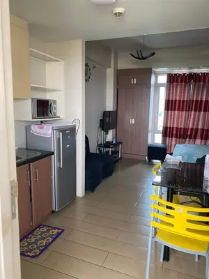 a kitchen and living room of a apartment at Favila Condotel Unit-150 Newport Boulevard near Airport Terminal 3 and all other Airport in Manila