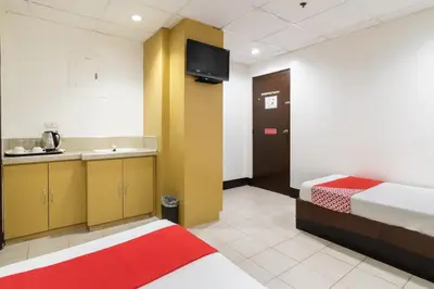 a room with a bed and a kitchen with a sink at Orange Nest Hotel in Manila