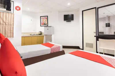 a hotel room with two beds and a tv at Orange Nest Hotel in Manila