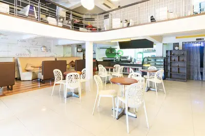 a restaurant with tables and chairs in a room at Orange Nest Hotel in Manila