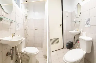 a bathroom with a toilet and a sink and a shower at Orange Nest Hotel in Manila