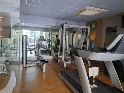 a gym with treadmills and machines in a room at NAIA Terminal 3 Condotel by Ann in Manila