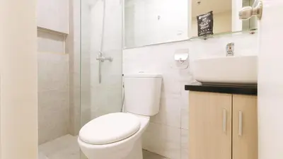 a white bathroom with a toilet and a sink at RedDoorz Plus at La Belle Residences Makati City in Manila
