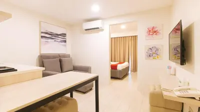 a living room with a couch and a table in a room at RedDoorz Plus at La Belle Residences Makati City in Manila