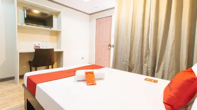 a room with a bed and a desk and a chair at RedDoorz Plus at Canley Residential in Manila