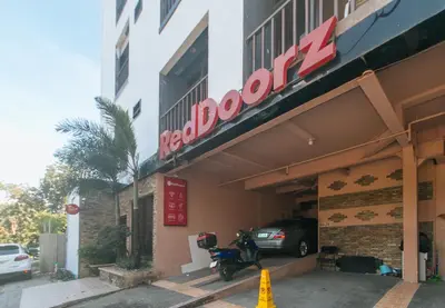 a motorcycle parked in front of a hotel at RedDoorz Plus at Canley Residential in Manila