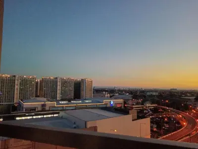a view of a city at night with a train station at Spring Residence in Manila