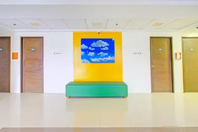 a room with a painting on the wall at Collection O Metro Manila near University Belt formerly 1318 Residences in Manila