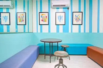 a waiting room with a table and two stools at Collection O Metro Manila near University Belt formerly 1318 Residences in Manila