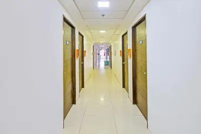 a corridor of a hospital with wooden walls and white tile floors at Collection O Metro Manila near University Belt formerly 1318 Residences in Manila