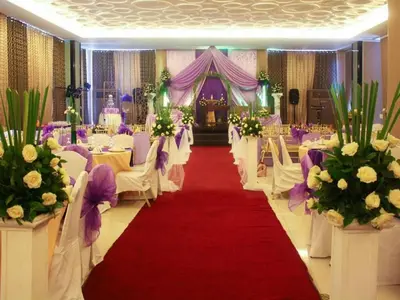 a banquet hall with white chairs and a red carpet at CityState Tower Hotel in Manila