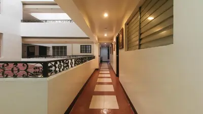 a corridor of a house with a balcony at El Rico Suite Makati by RedDoorz in Manila
