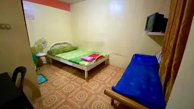 a small room with a bed and a tv at Belen Favila Transient rooms near Airport Terminal 3 in Manila