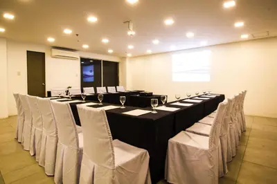 a row of tables and chairs in a room at Jade Hotel and Suites in Manila