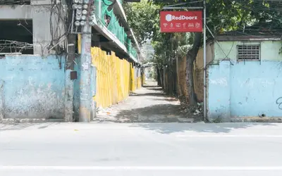 an empty street with a sign on the side of a building at RedDoorz Plus near Tambo Paranaque in Manila