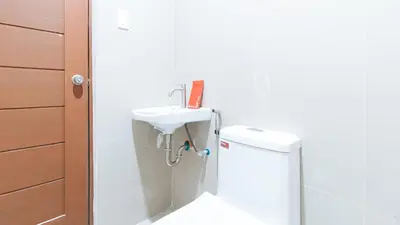 a white bathroom with a sink and a toilet at RedDoorz at Good 101 Paranaque in Manila