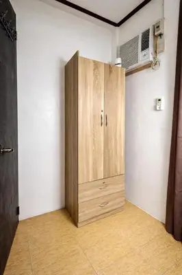 a wooden cabinet in the corner of a room at Transient Home at Tierra Vista near SM Dasma with Wifi and Netflix in Mabatang