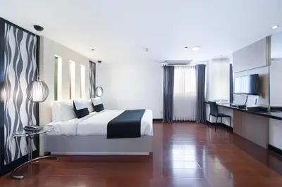a hotel room with a bed and a kitchen at Y2 Residence Hotel Managed by HII in Manila