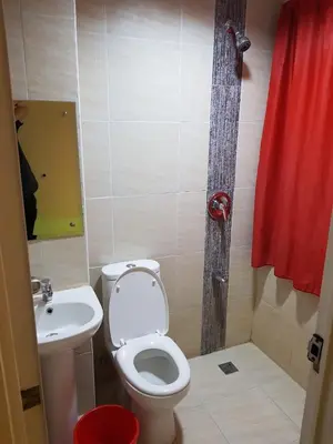 a bathroom with a toilet and a sink at My Inn Calamba in Calamba