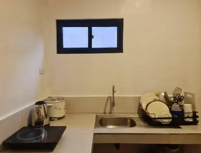 a kitchen counter with a sink and a window at Muji-inspired Home, 2-BR Bungalow Home Trece Martires in Trece Martires