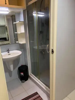 a bathroom with a shower and a sink at Wind and Sea at Sea Residences in Manila