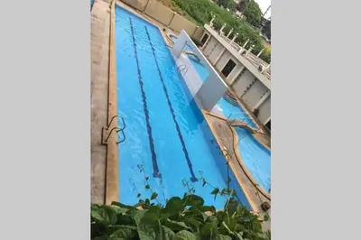 a large swimming pool with a blue water at CENTROPOLIS 3, Tropical Modern in Manila