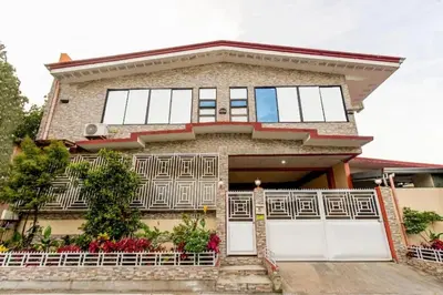 a house with white doors and a fence at La Belladoza near NAIA T1 Airport in Manila