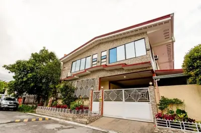 a building with a lot of windows and a garage at La Belladoza near NAIA T1 Airport in Manila