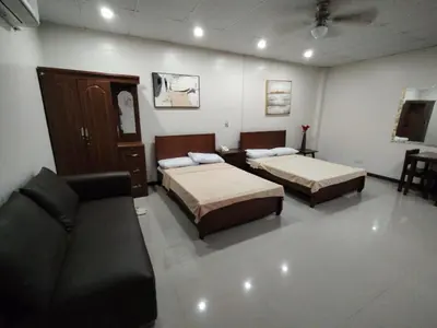 a living room with two beds and a couch at La Belladoza near NAIA T1 Airport in Manila