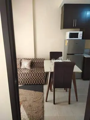 a living room with a table and a couch at The Rochester Condo in Manila