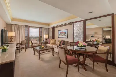 a living room with a couch and a table at The Manila Hotel in Manila