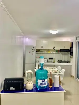 a kitchen with a counter top with a blue bottle on it at Cozy Central - Near arca south signal taguig in Manila