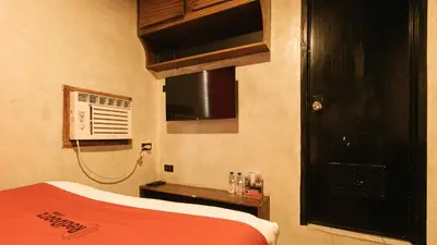 a bedroom with a red bed and a black door at RedDoorz @ Good 101 Quiricada Manila in Manila