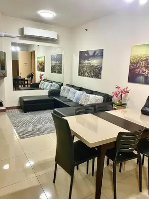 a living room with a couch and a table at Field Residences in Manila