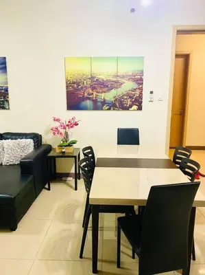 a dining room with a table and chairs at Field Residences in Manila