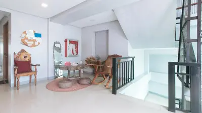 a living room with a table and chairs at Budget Backpackers Transient House near NAIA by RedDoorz in Manila