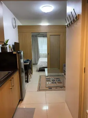 a kitchen with a stove in the middle of a room at MOA staycation Shell Residences Pasay city darpm in Manila