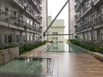 an empty hallway of a building with a pool of water at Staycation Taft Ave DLSU Green Res by darpm in Manila