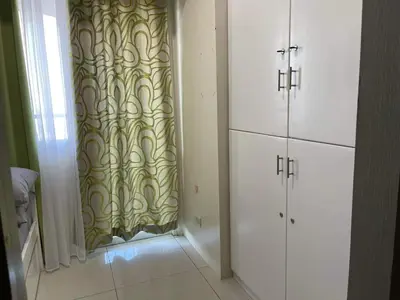 a room with a shower curtain and white cabinets at Staycation Taft Ave DLSU Green Res by darpm in Manila