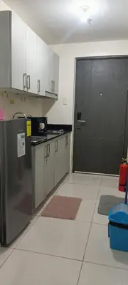 a kitchen with a stainless steel refrigerator and a black door at Staycation Taft Ave DLSU Green Res by darpm in Manila