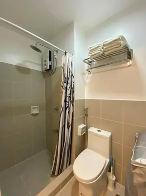 a bathroom with a toilet and a shower at A Cozy 1 Bedroom Unit with a Parking at Tower 2 South Residences SM Southmall in Manila